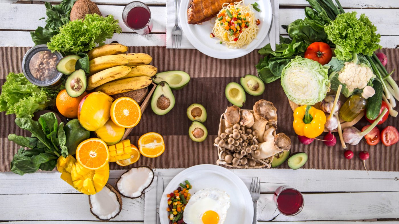 Lunch at a white wooden table with healthy organic food . The view from the top . The concept of healthy and home-cooked food