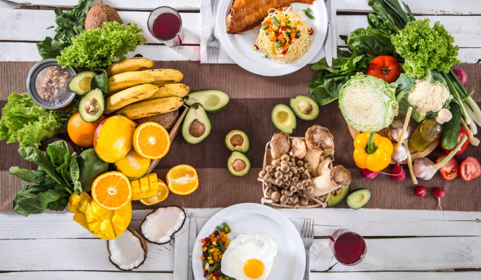 Lunch at a white wooden table with healthy organic food . The view from the top . The concept of healthy and home-cooked food